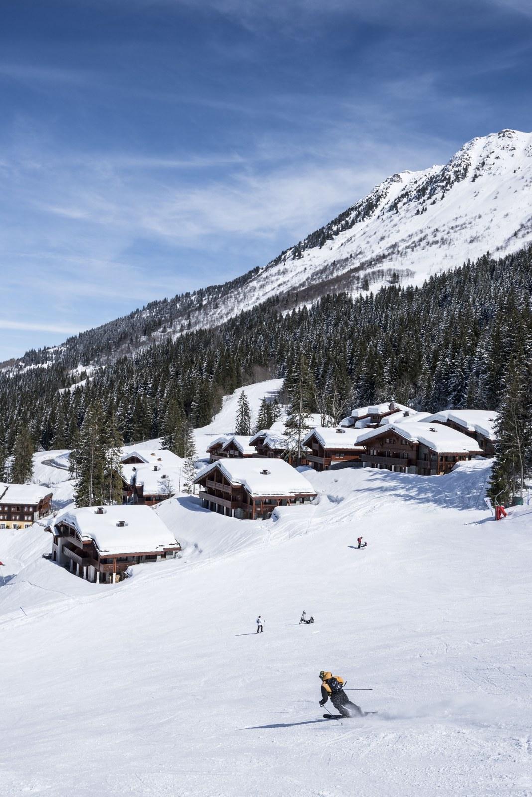 Skier on a snowy slope beside the Valmorel Chalet-Apartments