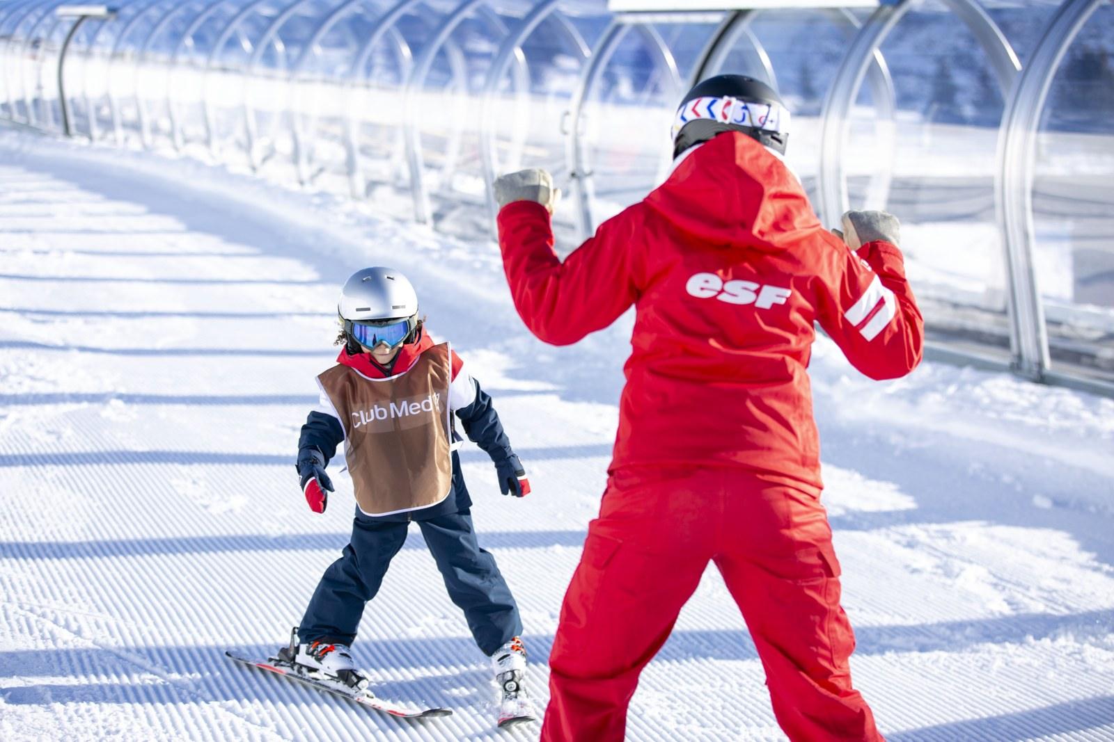 Child learning to ski with an instructor at Club Med La Rosière