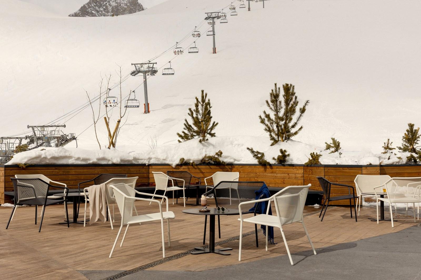 Terrace seating and a chairlift at Club Med Tignes