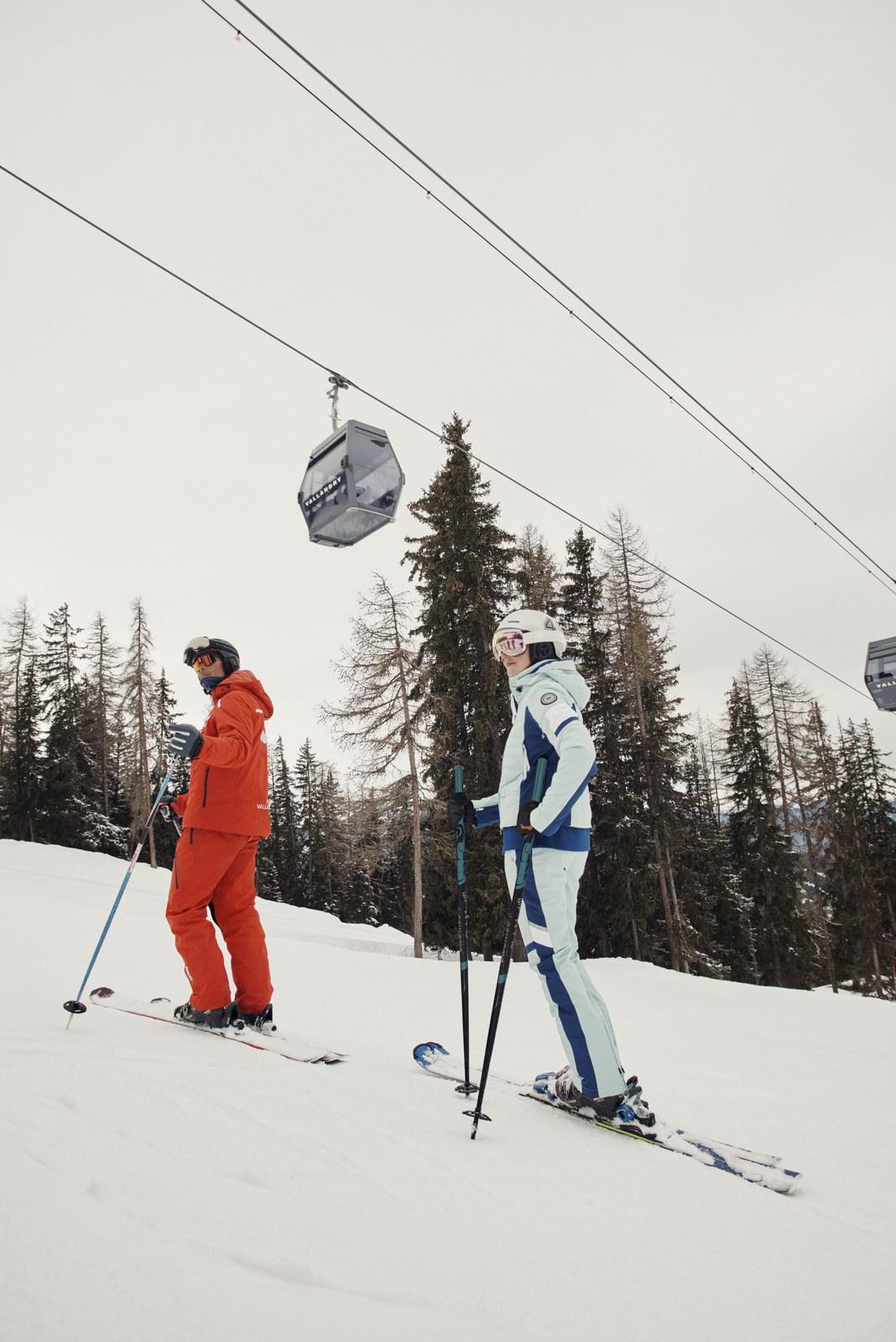 Skiers beneath a gondola at Peisey-Vallandry