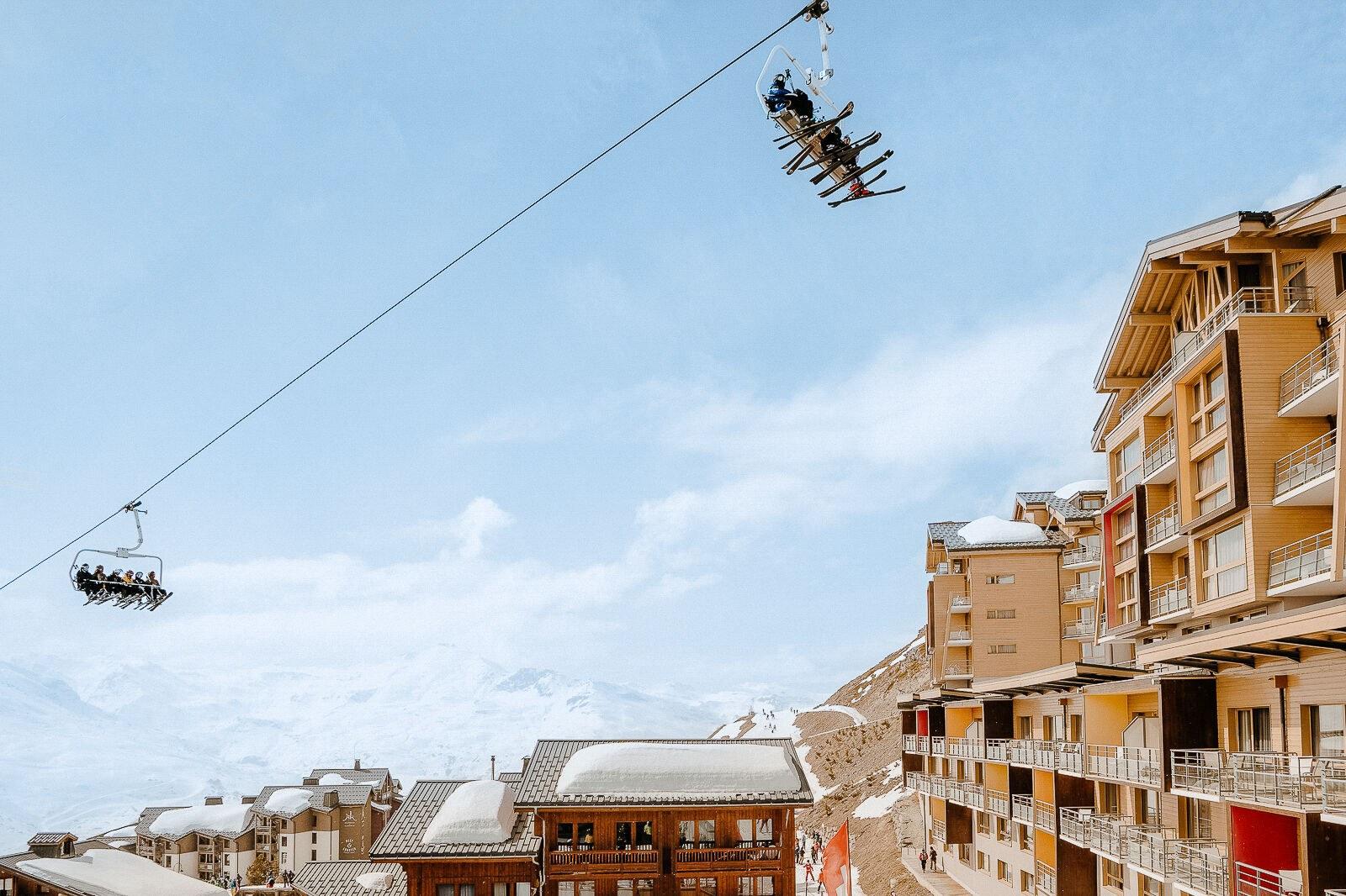 Snow-covered resort buildings and chairlift at Club Med Val Thorens Sensations