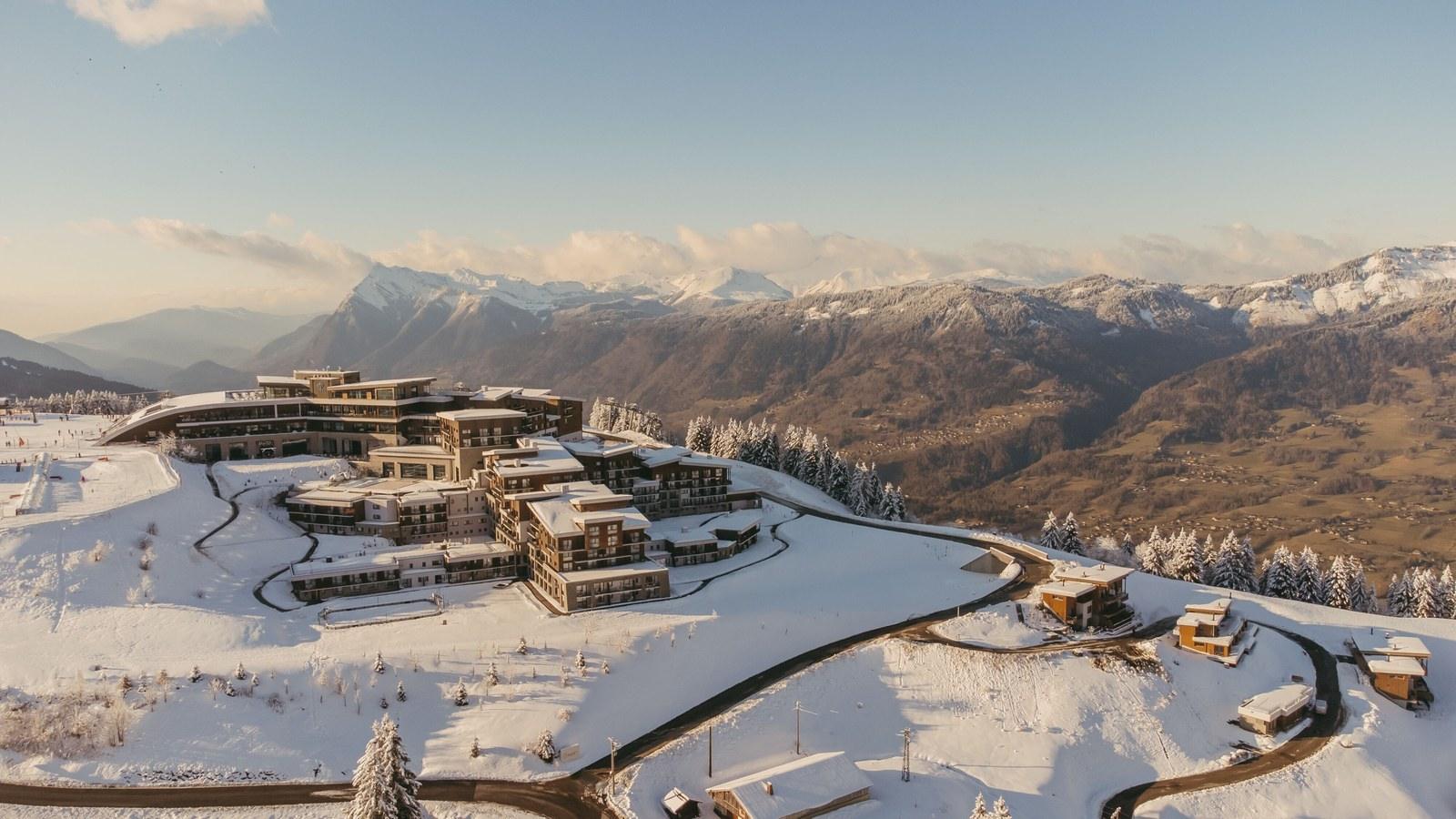 Club Med Grand Massif Samoëns Morillon surrounded by snow and mountains in warm light