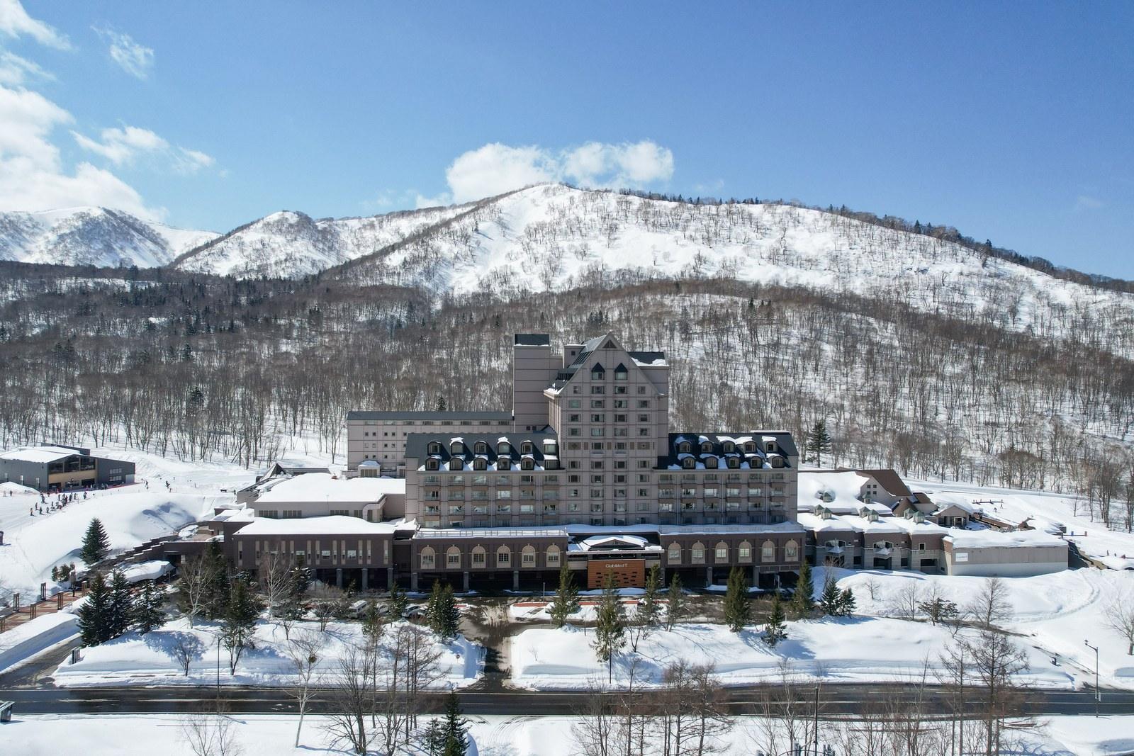 Club Med Kiroro Grand with snowy mountains behind the hotel