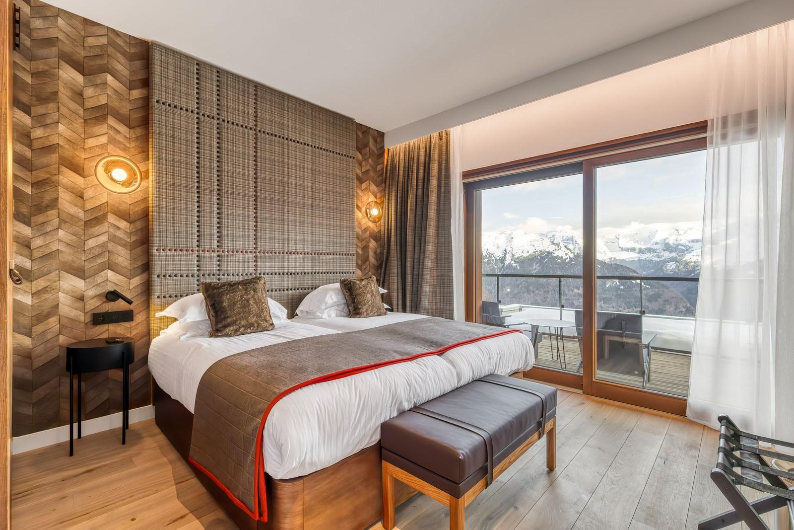 Bedroom with mountain views at the Grand Massif Chalet-Apartments