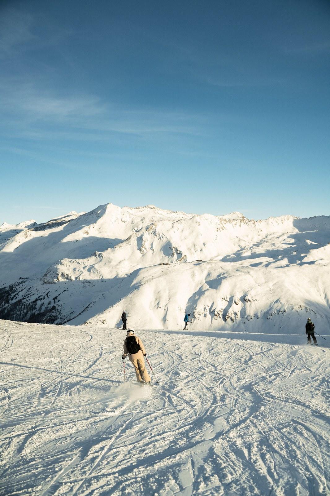 Skiers on the snow-covered slopes of Val d’Isère