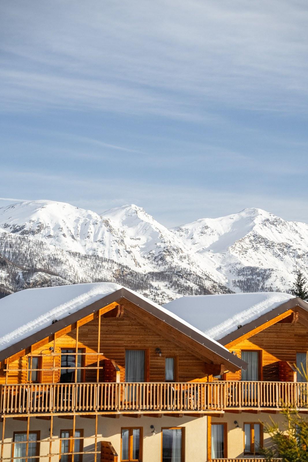 Snow-covered chalets and mountains at Club Med Pragelato Sestriere