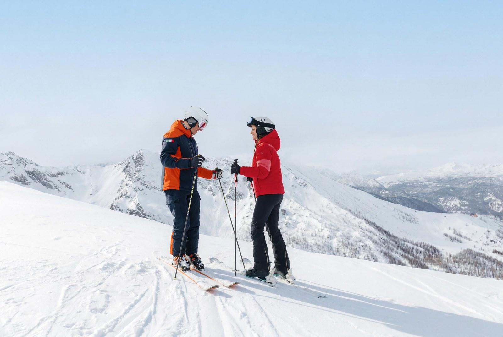 Two skiers in the alpine landscape at San Sicario