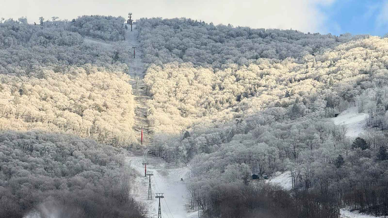 Snow-covered forest and ski lifts at Beidahu in China